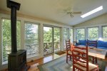 Sun room has free standing, gas fire place